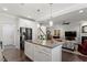 Open kitchen with granite counters, stainless steel appliances, and view to the living area at 468 Talons Rest Way, Cary, NC 27513