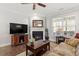 Comfortable living room featuring a fireplace, hardwood floors, and natural light with cozy furnishings at 468 Talons Rest Way, Cary, NC 27513