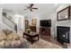 Spacious living room with hardwood floors, a fireplace, and seamless flow to the entryway and kitchen at 468 Talons Rest Way, Cary, NC 27513
