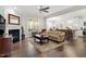 Cozy living room with a fireplace, hardwood floors, and an open layout leading to the kitchen at 468 Talons Rest Way, Cary, NC 27513