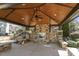 View of community pavilion's interior showing fireplace, seating, and wood-finished ceiling at 468 Talons Rest Way, Cary, NC 27513