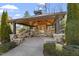 Outdoor pavilion with stone fireplace, seating, and wood ceiling, perfect for gatherings at 468 Talons Rest Way, Cary, NC 27513