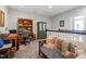 Cozy upstairs sitting room with a comfortable couch, bookcase, and natural light at 468 Talons Rest Way, Cary, NC 27513