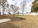 Exterior view of the spacious backyard with mature trees and a privacy fence at 4704 Upchurch Ln, Wake Forest, NC 27587