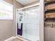 Modern bathroom featuring a glass enclosed shower and built-in storage shelves at 4704 Upchurch Ln, Wake Forest, NC 27587