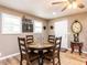 Cozy dining area with round table, wood chairs, and ample natural light from nearby windows at 4704 Upchurch Ln, Wake Forest, NC 27587