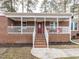 Inviting front entrance with a brick facade, covered porch, and well-manicured landscaping at 4704 Upchurch Ln, Wake Forest, NC 27587