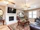 Inviting living room featuring a white brick fireplace, elegant decor, and hardwood flooring at 4704 Upchurch Ln, Wake Forest, NC 27587