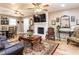 Comfortable living room boasts a white fireplace, stylish furnishings, and seamless flow into dining area at 4704 Upchurch Ln, Wake Forest, NC 27587