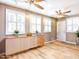Bright living area with wood floors, recessed lighting, ceiling fans, and stylish built-in storage at 4704 Upchurch Ln, Wake Forest, NC 27587