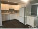 Updated kitchen with white cabinets, modern appliances, and ample counter space at 500 Woodcroft Pkwy # 16D, Durham, NC 27713