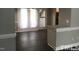 Open-concept living space with sleek floors and a door leading to the outdoor deck at 500 Woodcroft Pkwy # 16D, Durham, NC 27713