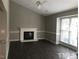 Bright living room with a fireplace, vaulted ceiling, and large windows for natural light at 500 Woodcroft Pkwy # 16D, Durham, NC 27713