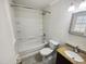 Bathroom features white shower and tub, white toilet, and tile flooring at 5614 Greenbay Dr, Durham, NC 27712