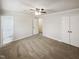 Neutral bedroom with gray carpet, closet and ceiling fan with lights at 5614 Greenbay Dr, Durham, NC 27712