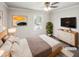 Bright bedroom featuring neutral walls, ceiling fan, bed, and natural light from the window at 5614 Greenbay Dr, Durham, NC 27712