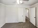 Neutral bedroom with gray carpet, closet and ceiling fan with lights at 5614 Greenbay Dr, Durham, NC 27712