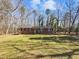 Charming brick ranch-style home with a well-manicured front yard and a covered carport at 5614 Greenbay Dr, Durham, NC 27712