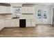 Bright kitchen featuring white cabinets, stainless steel appliances, and vinyl flooring at 5614 Greenbay Dr, Durham, NC 27712