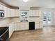Updated kitchen featuring white cabinets, stainless steel appliances, and vinyl flooring at 5614 Greenbay Dr, Durham, NC 27712