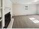 Living room featuring a fireplace, a window, carpet flooring, and painted walls at 5614 Greenbay Dr, Durham, NC 27712