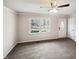 Empty living room showcasing ample natural light with neutral walls and carpet at 5614 Greenbay Dr, Durham, NC 27712