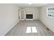 Spacious living room featuring fireplace, a window, carpet flooring, and painted walls at 5614 Greenbay Dr, Durham, NC 27712