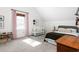 Bright bedroom featuring carpet, a crib, bed, and a window with red and white checkered curtains at 701 S Fifth St, Mebane, NC 27302