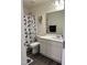 Bathroom with a Mickey Mouse shower curtain and a white vanity at 704 Mirror Pond Dr, Zebulon, NC 27597