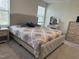 A bedroom with a large upholstered bed and a vanity at 704 Mirror Pond Dr, Zebulon, NC 27597