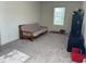 A spare bedroom features neutral walls, carpet floors, and a window for natural light at 704 Mirror Pond Dr, Zebulon, NC 27597
