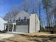 Charming two-story home with gray and white siding, a two-car garage, and a well-manicured front lawn at 704 Mirror Pond Dr, Zebulon, NC 27597