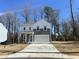 Charming two-story home with gray and white siding, a two-car garage, and a well-manicured front lawn at 704 Mirror Pond Dr, Zebulon, NC 27597