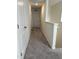 A carpeted hallway with white walls and doors at 704 Mirror Pond Dr, Zebulon, NC 27597