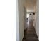 Inviting hallway with hardwood floors and neutral walls leads to the living and dining area at 704 Mirror Pond Dr, Zebulon, NC 27597