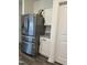 Gleaming stainless steel refrigerator with a close view of white cabinets and granite countertops at 704 Mirror Pond Dr, Zebulon, NC 27597