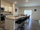 The kitchen showcases granite counters, bar stool seating, stainless appliances, and is connected to the dining area at 704 Mirror Pond Dr, Zebulon, NC 27597