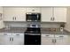 Bright kitchen showcasing granite countertops, white cabinets, and stainless steel appliances, blending style and functionality at 704 Mirror Pond Dr, Zebulon, NC 27597