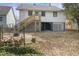 Spacious backyard with a fire pit, seating area, and stairs to the back door at 709 North St, Durham, NC 27701