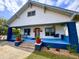 Charming two-story home with a blue-painted porch, swing, and manicured landscaping at 709 North St, Durham, NC 27701