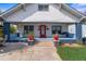 Inviting home showcasing a blue-painted porch, swing, and vibrant landscaping at 709 North St, Durham, NC 27701