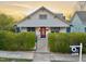 Delightful home with a red door, manicured landscaping, and a 'For Sale' sign at 709 North St, Durham, NC 27701