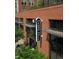 Exterior of Durham Food Hall in a brick building with big windows and plenty of greenery at 709 North St, Durham, NC 27701