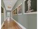 Inviting hallway featuring hardwood floors, gallery lighting, and decorative art pieces at 709 North St, Durham, NC 27701