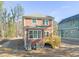 Two-story house with an open wood deck and a green roof with trees nearby at 717 Heidelberg St, Durham, NC 27704