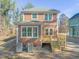 Two-story house with an open wood deck and a green roof with trees nearby at 717 Heidelberg St, Durham, NC 27704