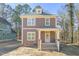 Charming two-story home featuring a welcoming front porch and neutral brown color palette at 717 Heidelberg St, Durham, NC 27704