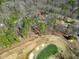 An aerial view of the home adjacent to a golf course with sand traps and pond at 103 Bruce Dr, Cary, NC 27511