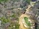 An aerial view of the home adjacent to a golf course with sand traps and pond at 103 Bruce Dr, Cary, NC 27511