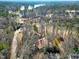 An aerial view of the home nestled amongst trees and a golf course with lake views at 103 Bruce Dr, Cary, NC 27511